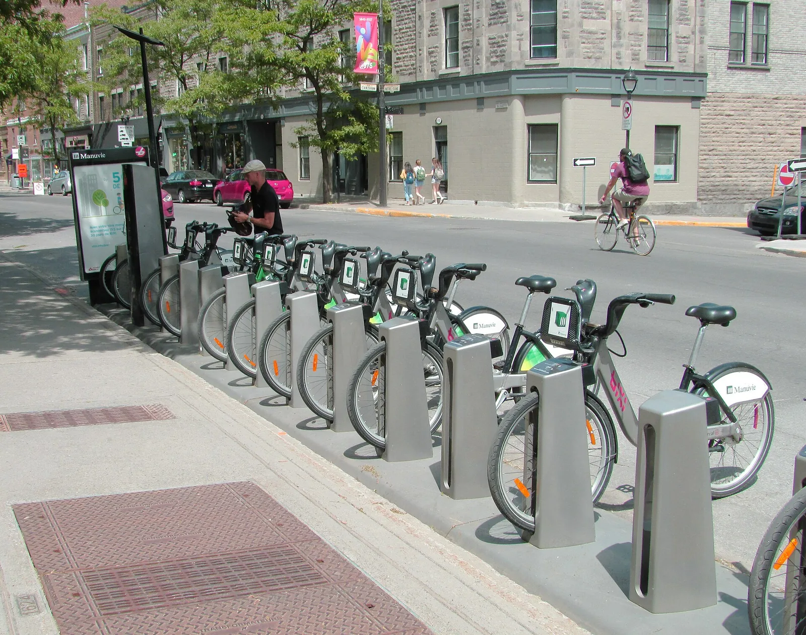 A row of BIXI bike-share bikes docked at a street station in Montreal