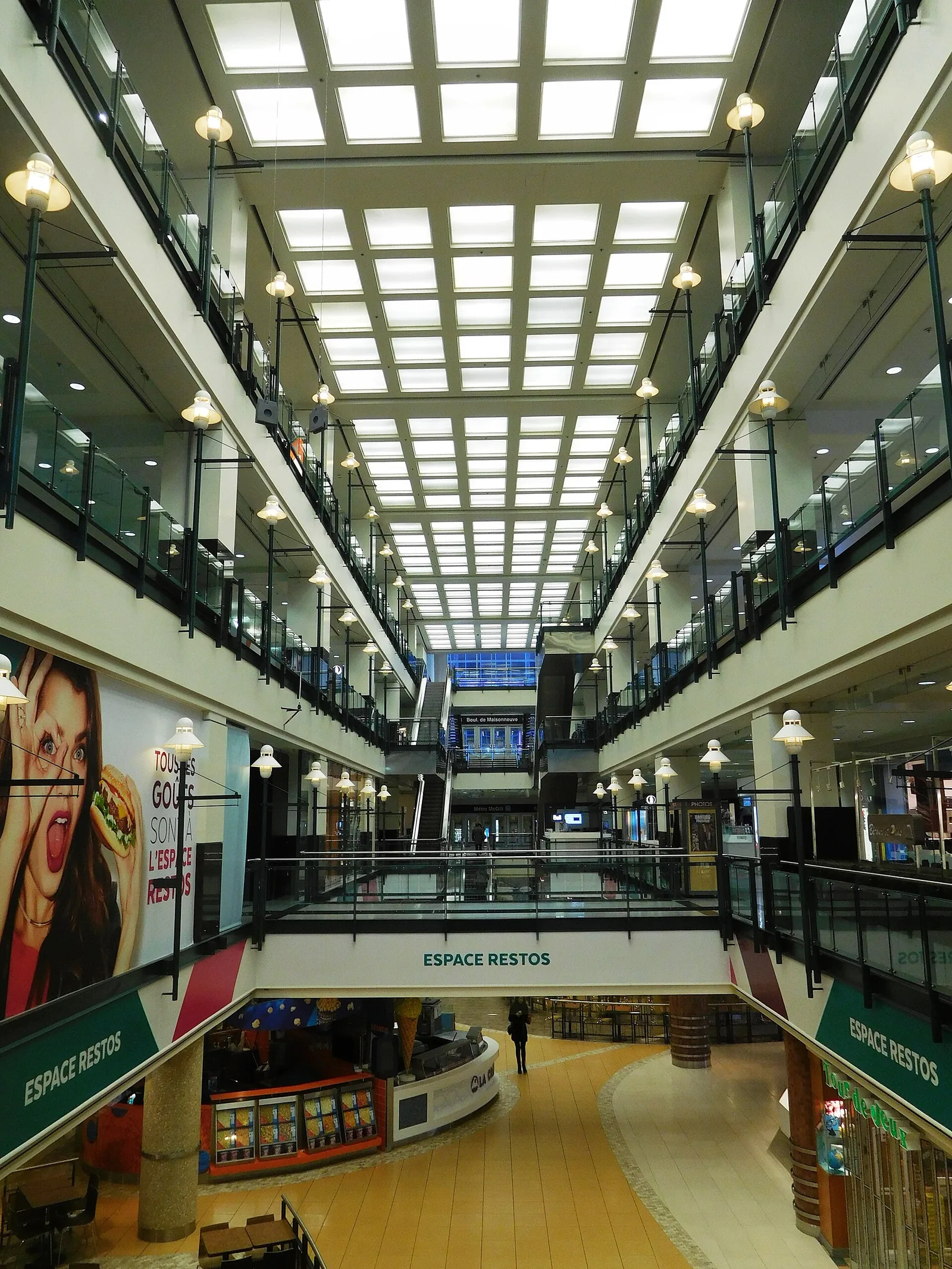 Skylit, multi-level interior of Centre Eaton de Montréal with shops on several floors