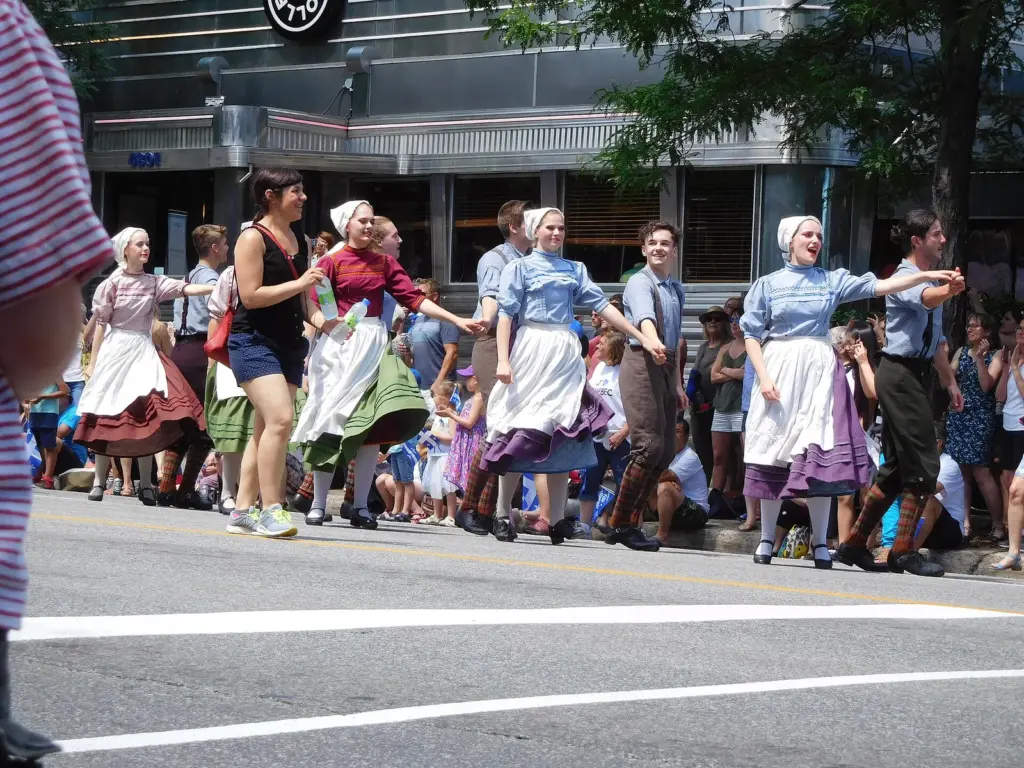 Folk dancers in traditional Québécois costume in the Fête nationale parade on rue Saint-Denis in Montreal