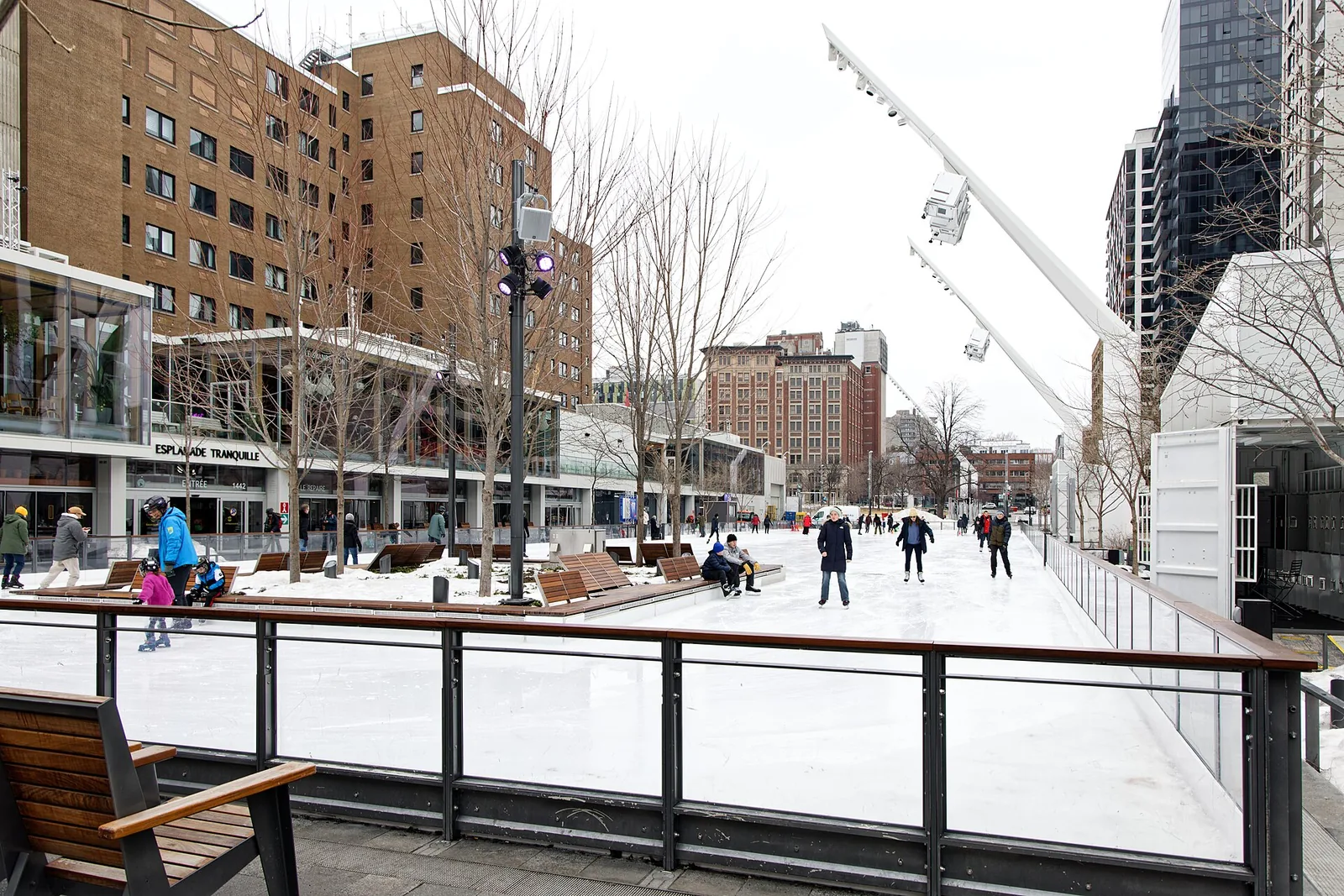 Skaters on the refrigerated Esplanade Tranquille rink, some of the best ice skating Montreal has downtown