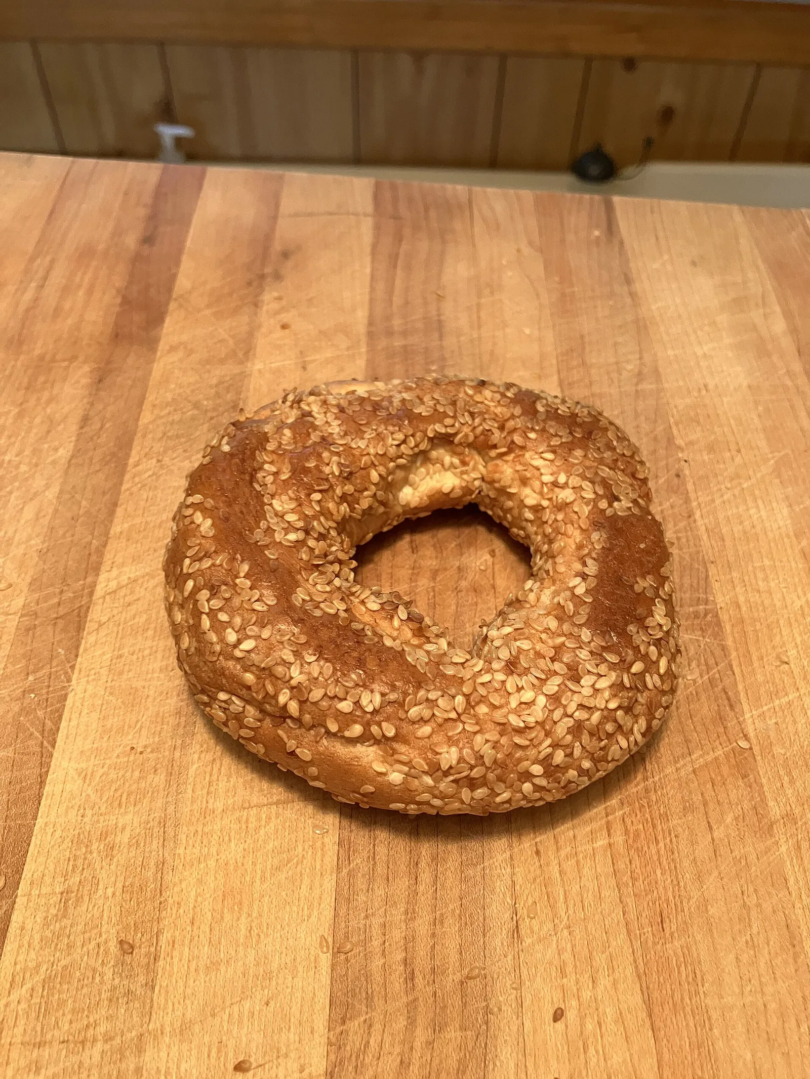 A sesame Montreal-style bagel from Fairmount Bagel on a wooden counter