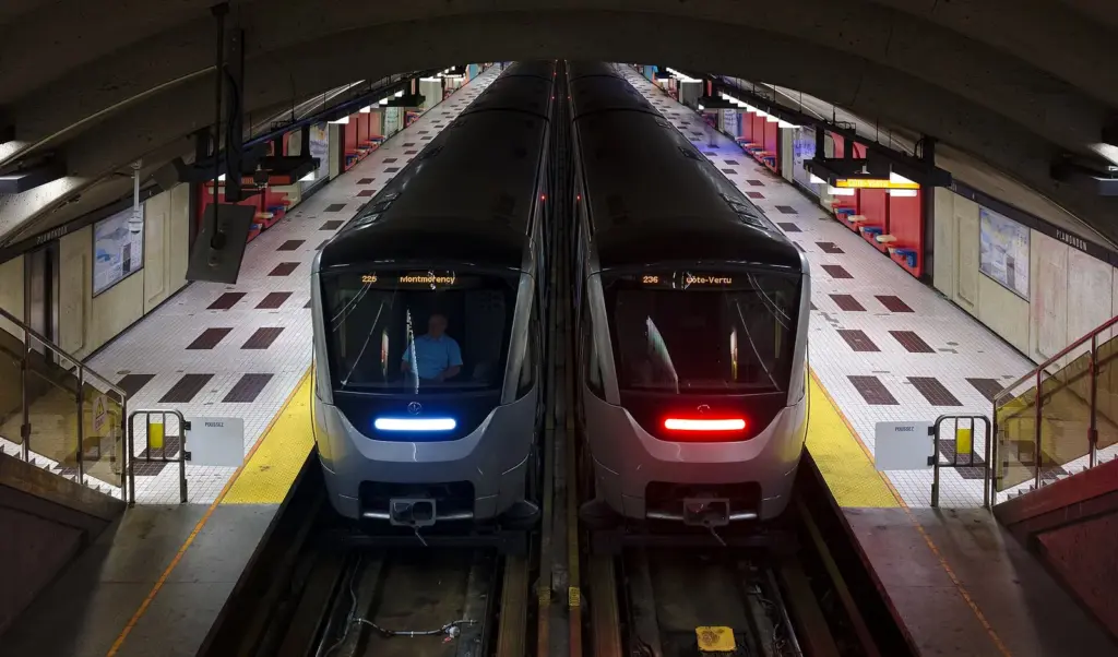Two Montreal metro trains side by side at the platforms of Plamondon station