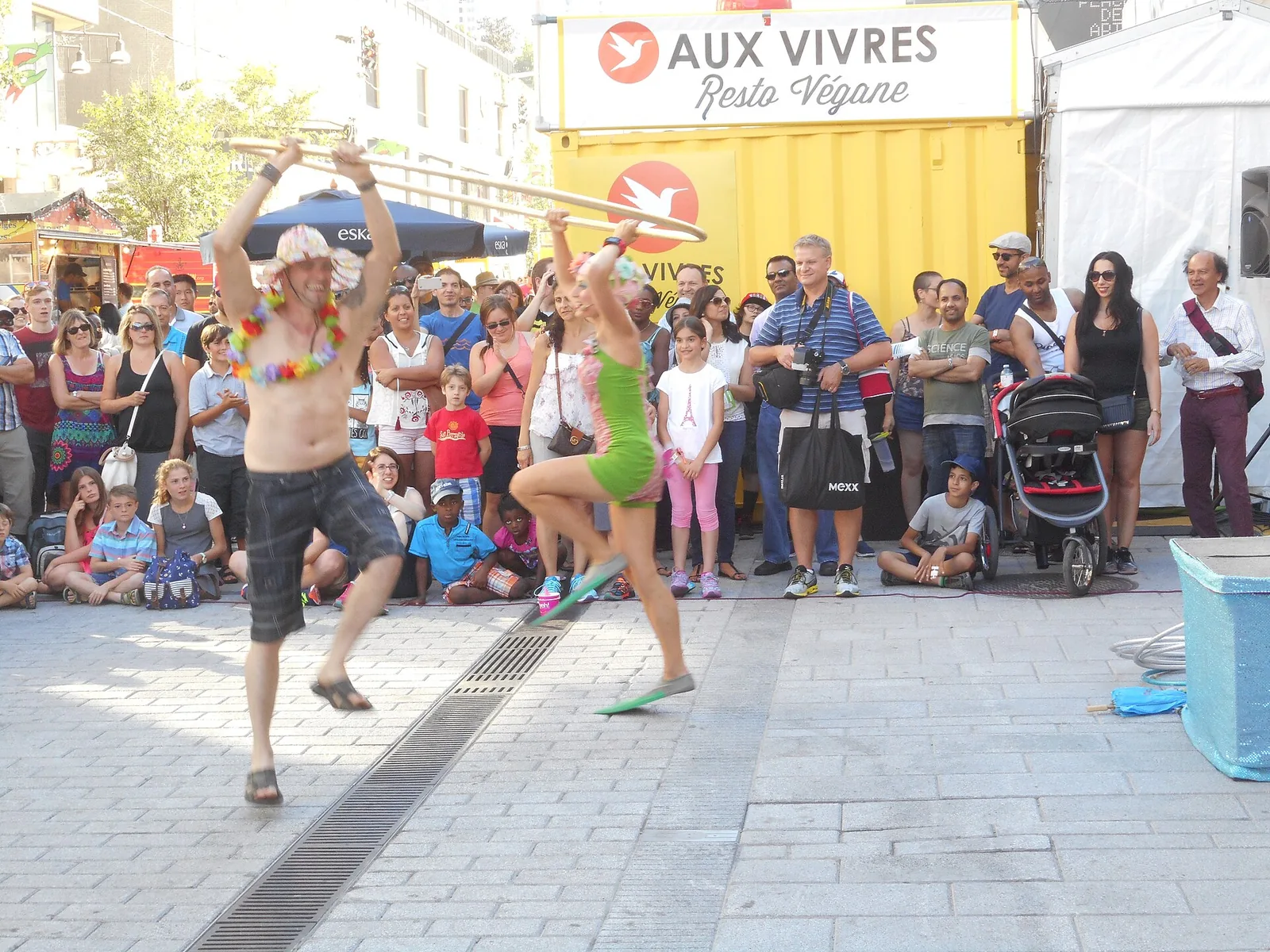 Street performers entertaining a crowd during Just for Laughs, one of the biggest Montreal festivals