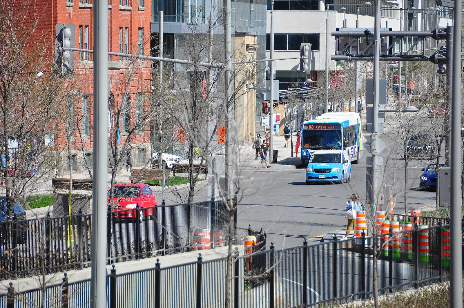 Orange construction cones and barriers along a downtown Montreal street in spring