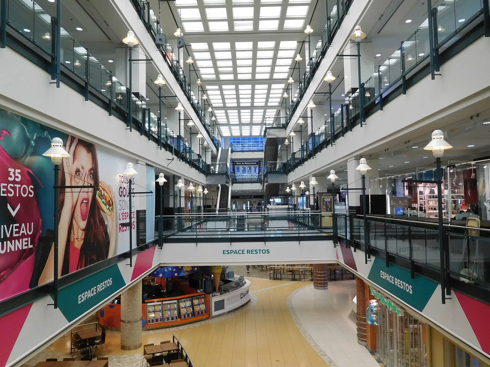 The multi-level interior of the Montreal Eaton Centre with its skylit atrium and shops