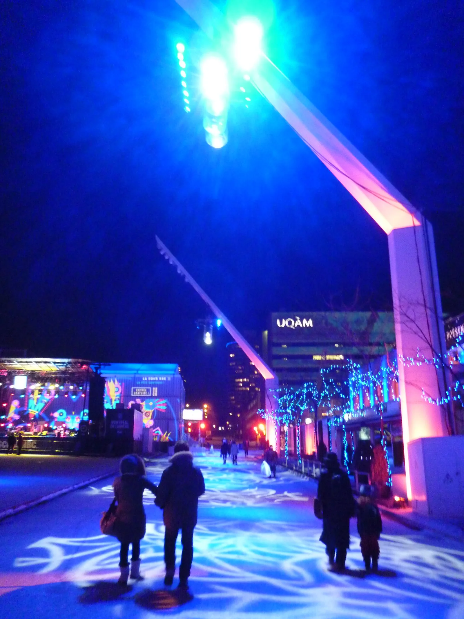 Blue-lit walkway and light installations at Montréal en Lumière near UQAM