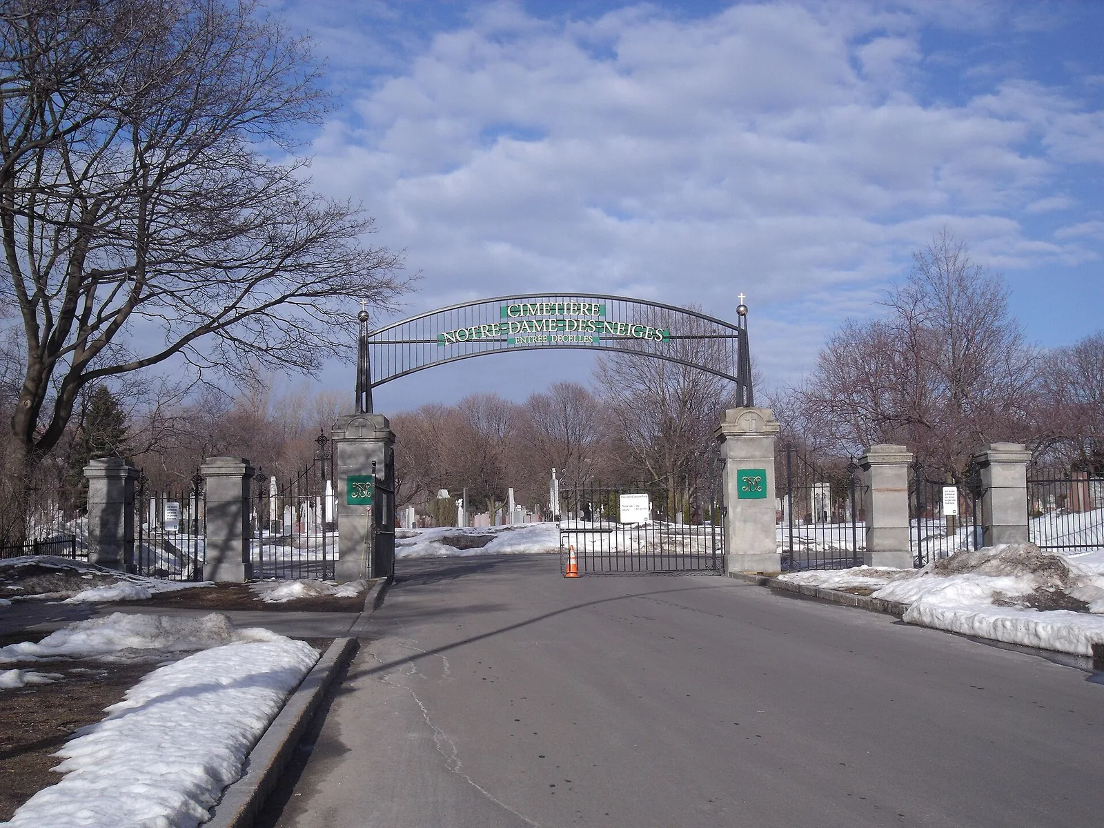 The arched iron gates of Notre-Dame-des-Neiges Cemetery on Mount Royal in early spring