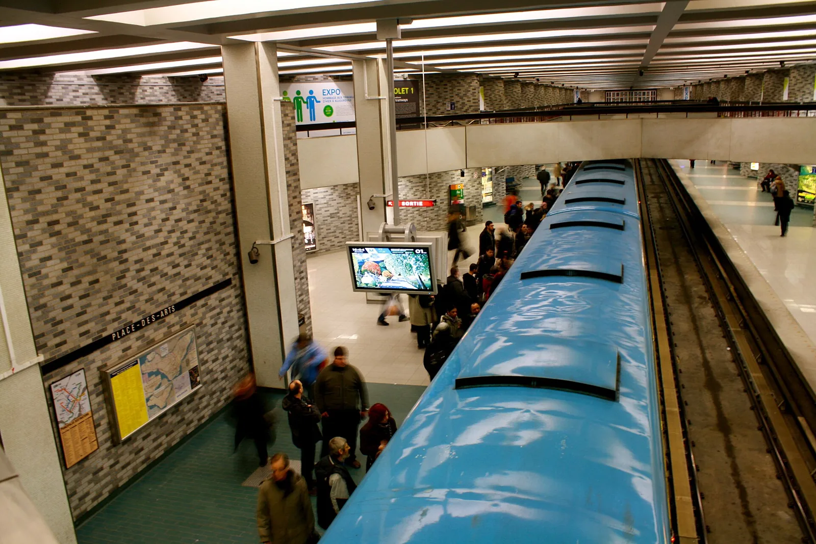 Commuters on the platform at Place-des-Arts, one of the metro stations that ties the Montreal underground city together