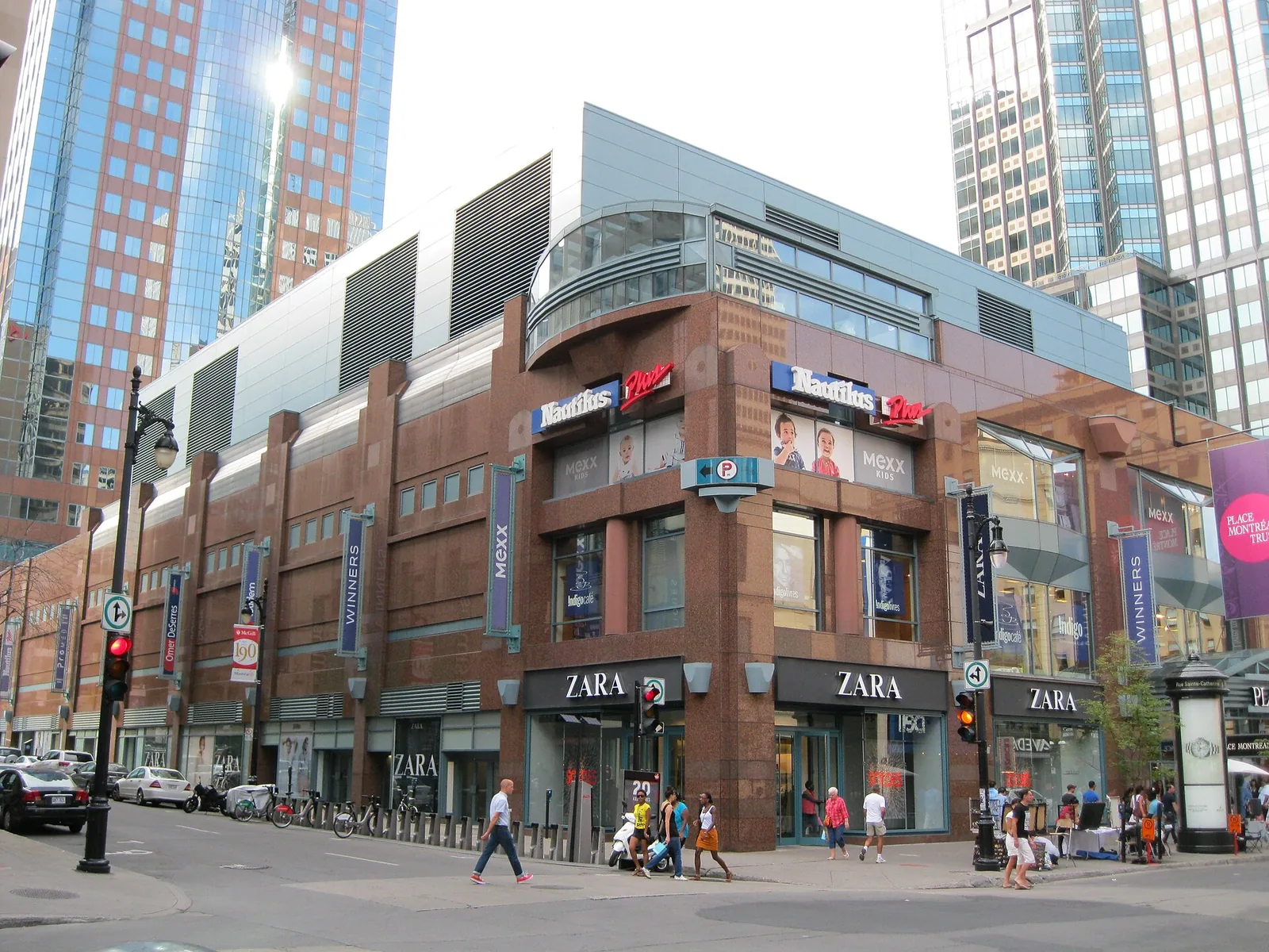 The red brick and glass corner of Place Montréal Trust on rue Sainte-Catherine