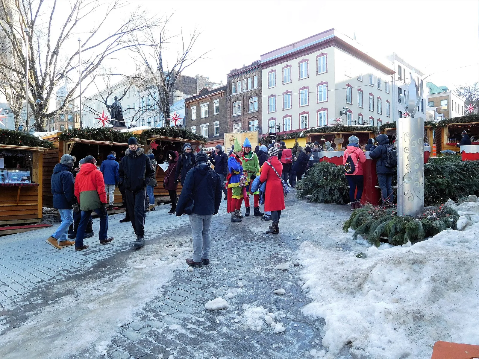 Wooden chalets and shoppers in winter coats at the German Christmas Market in Old Québec