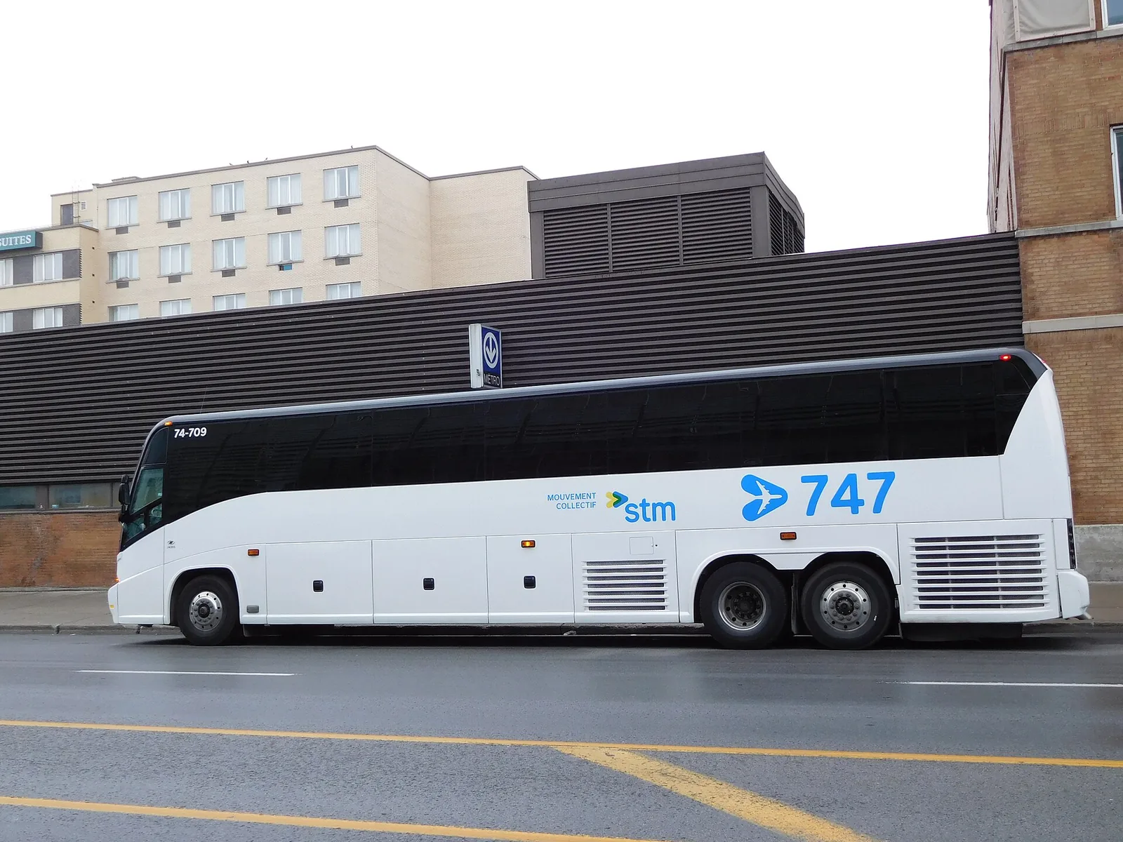 A white STM 747 express coach, the bus between Montreal airport and downtown