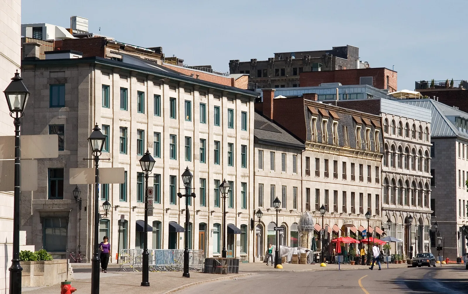 Greystone buildings and lamp posts along rue de la Commune in Old Montreal, near the Bota Bota boarding point